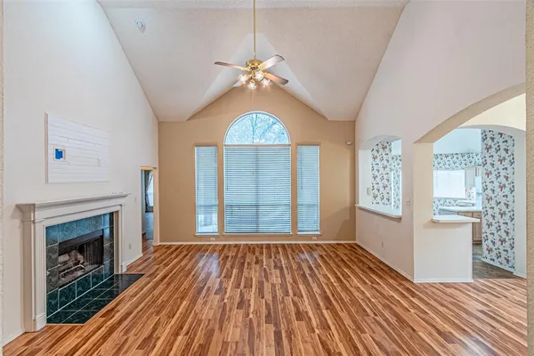 a view of empty room with wooden floor fireplace and windows