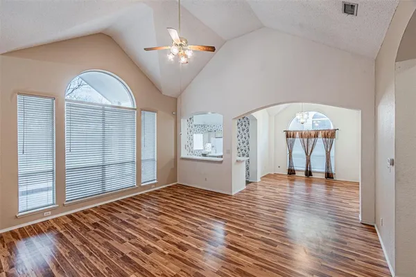 a view of a room with wooden floor chandelier and entryway