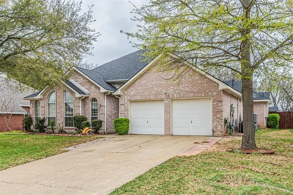 a front view of house with yard and trees around