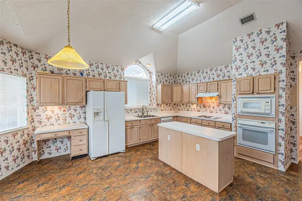 a kitchen with cabinets and window