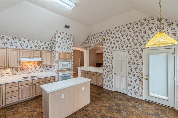 a room with fireplace and cabinets