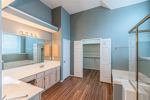 a spacious bathroom with a double vanity sink and a large mirror