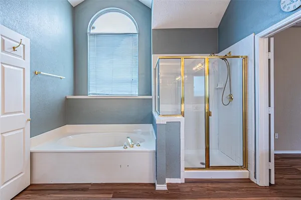 a bathroom with a bathtub and a shower