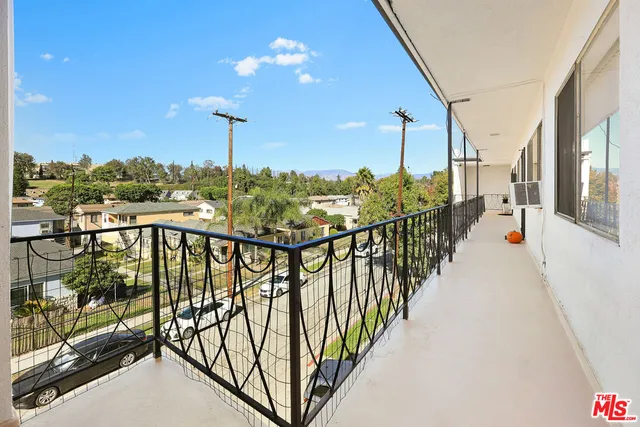 a view of a balcony with furniture