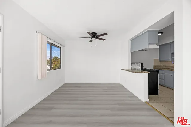 a kitchen with stainless steel appliances granite countertop a sink and a stove