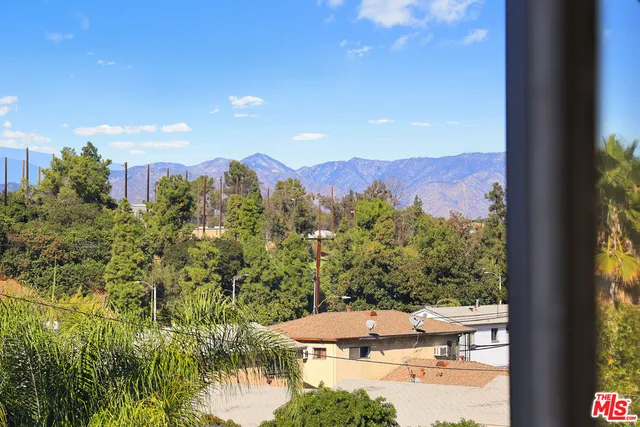 a view of a balcony and trees