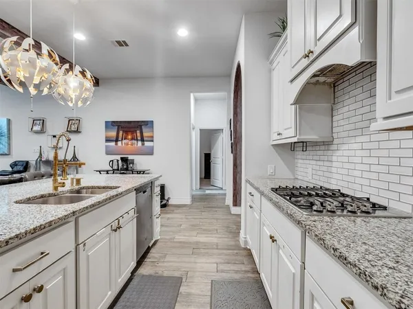 a kitchen with a sink and cabinets