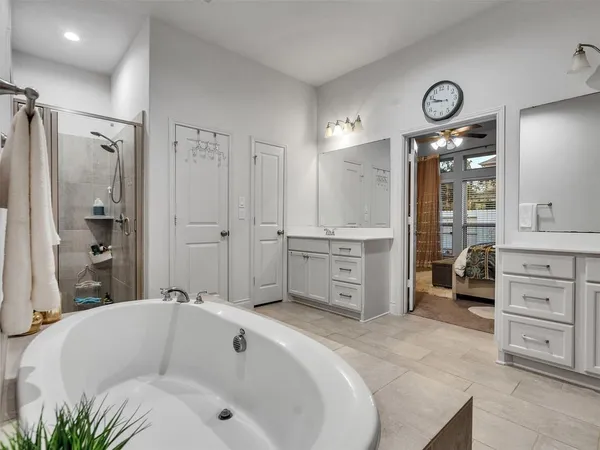a en suite bathroom with a double vanity sink a mirror and a shower