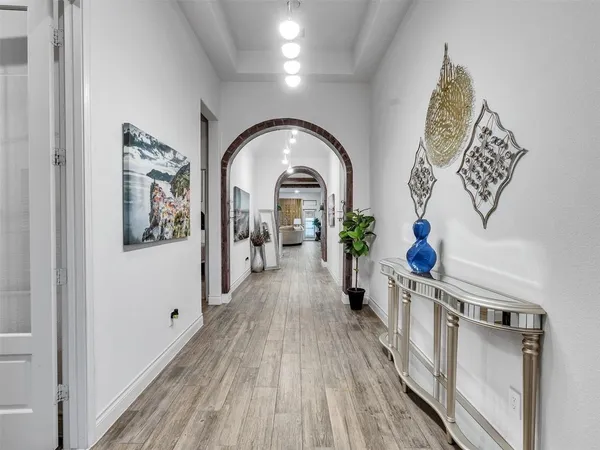 a view of a hallway view with wooden floor and staircase