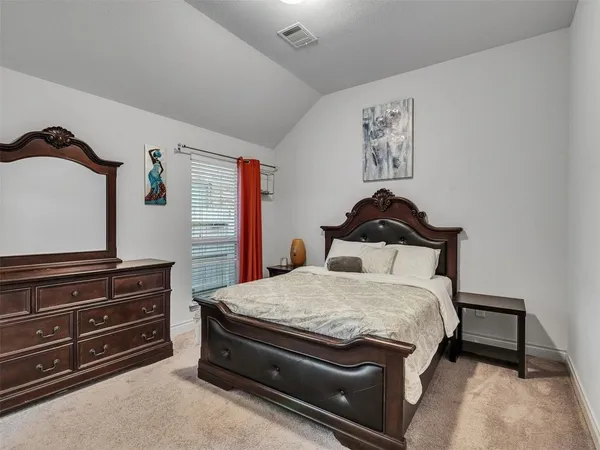 a bedroom with a bed and a dresser