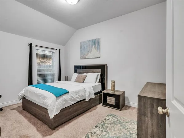 a bedroom with a bed and a night stand