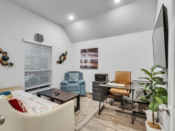 a living room with furniture and a potted plant