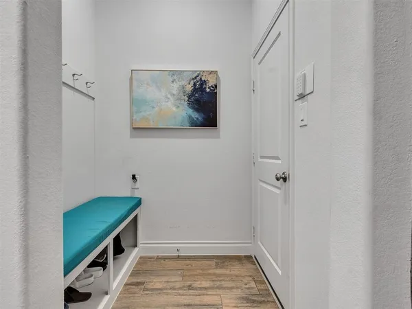 a hallway with front door and wooden floor