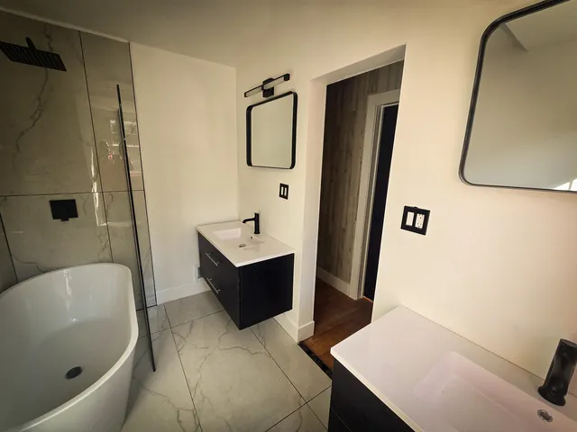 a view of empty room with wooden floor and ceiling fan