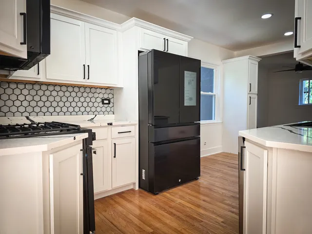 a kitchen with a refrigerator and a stove
