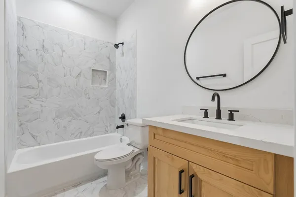 a bathroom with a sink a toilet and a mirror