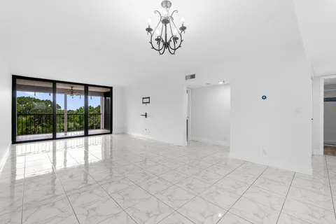 a view of empty room with a large window