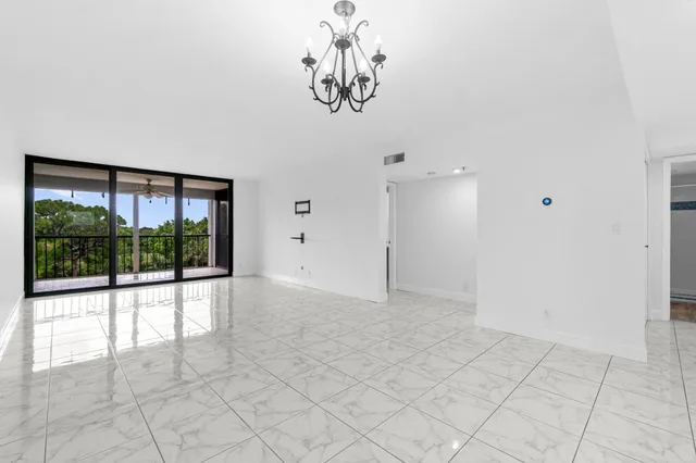 a view of empty room with a large window