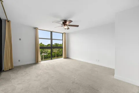a view of room with a ceiling fan and a window