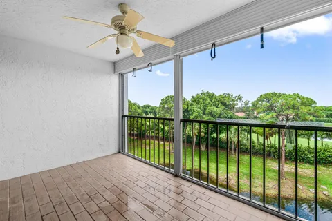 a view of a balcony with ceiling fan