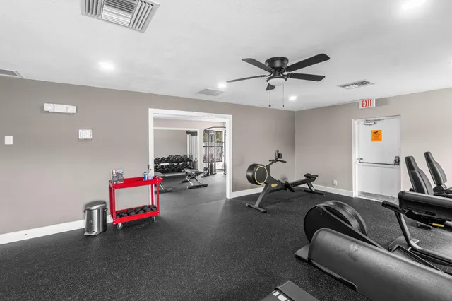a living room with furniture and a gym machine