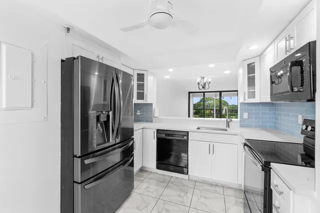 a kitchen with a sink stainless steel appliances and cabinets