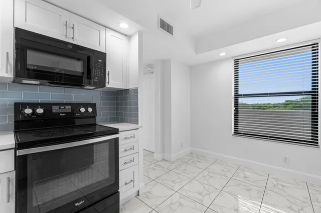 a kitchen with a stove and a microwave