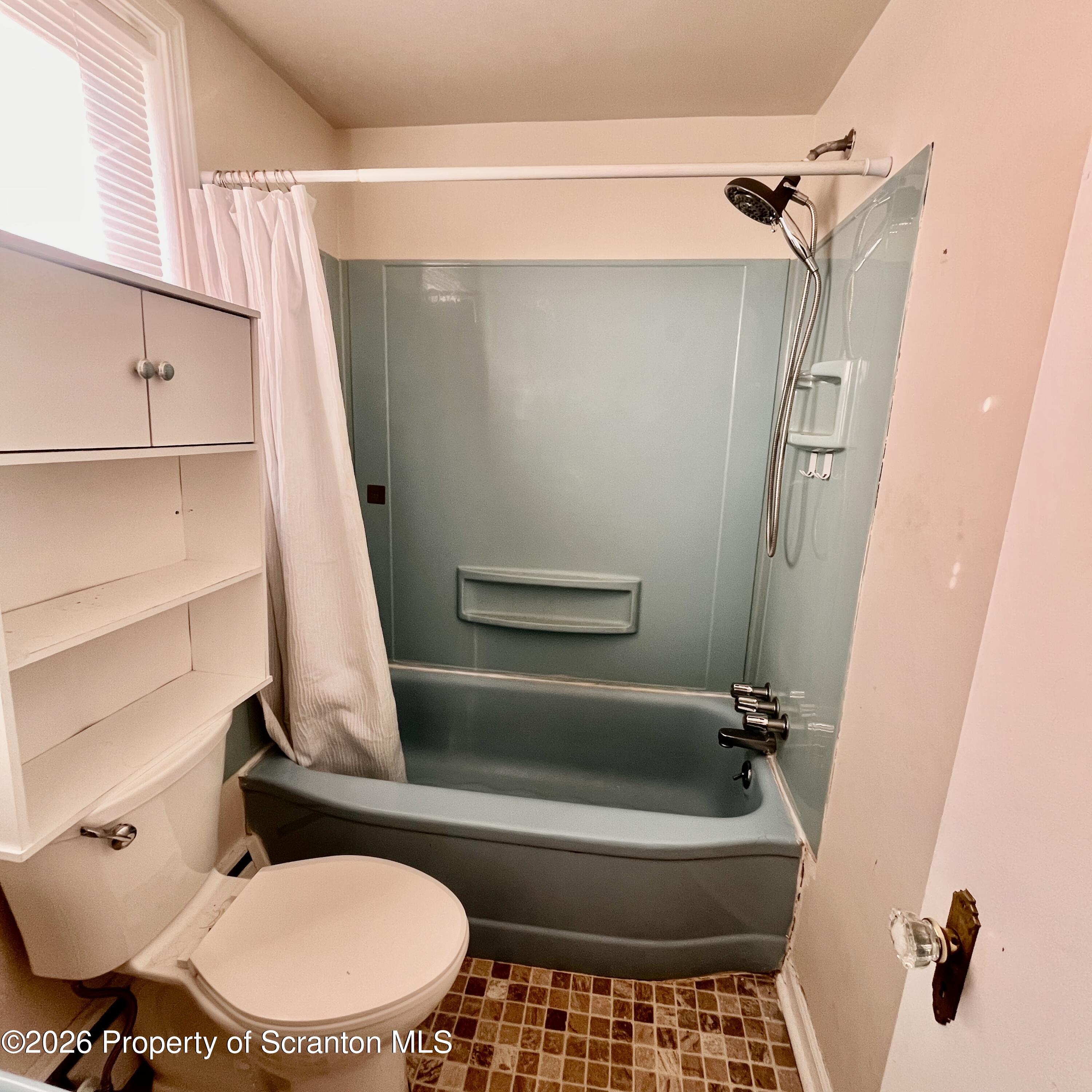 707 Prospect Avenue, Unit REAR Scranton, PA 18505 - Photo 11 of 11 a bathroom with a sink a toilet a mirror and shower
