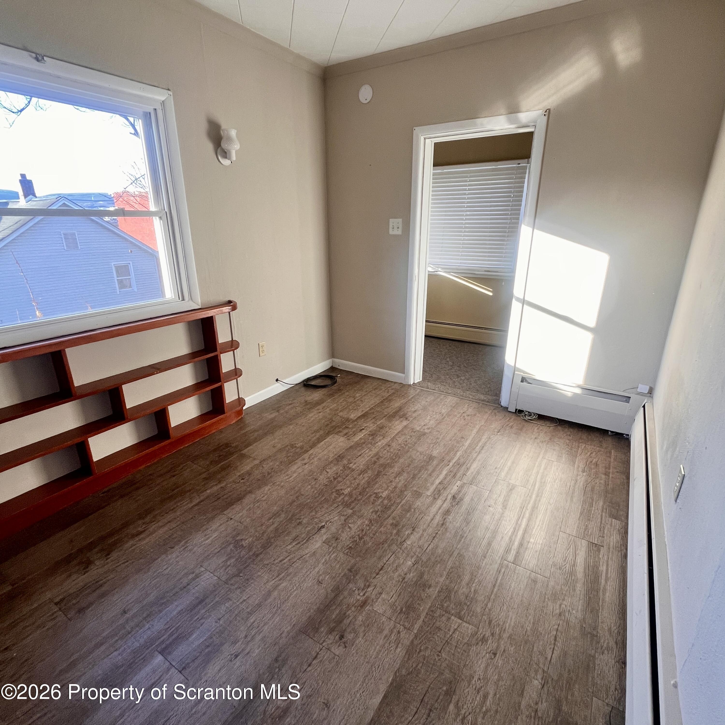 707 Prospect Avenue, Unit REAR Scranton, PA 18505 - Photo 5 of 11 a view of room with window and wooden floor