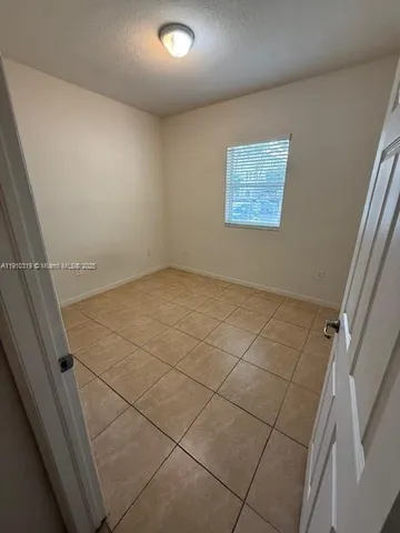 a white toilet sitting next to a shower