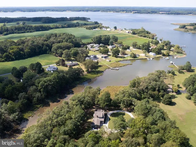 an aerial view of a houses with a lake view