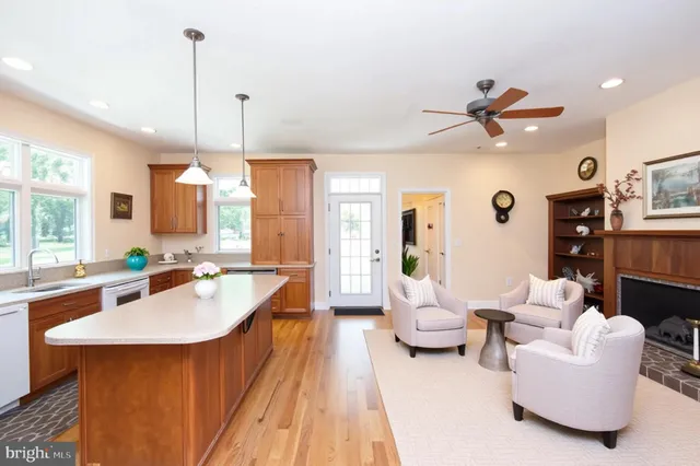 a large room with kitchen island a large window in it