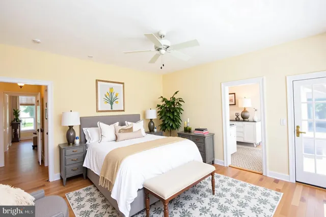 a bedroom with a bed rug and wooden floor