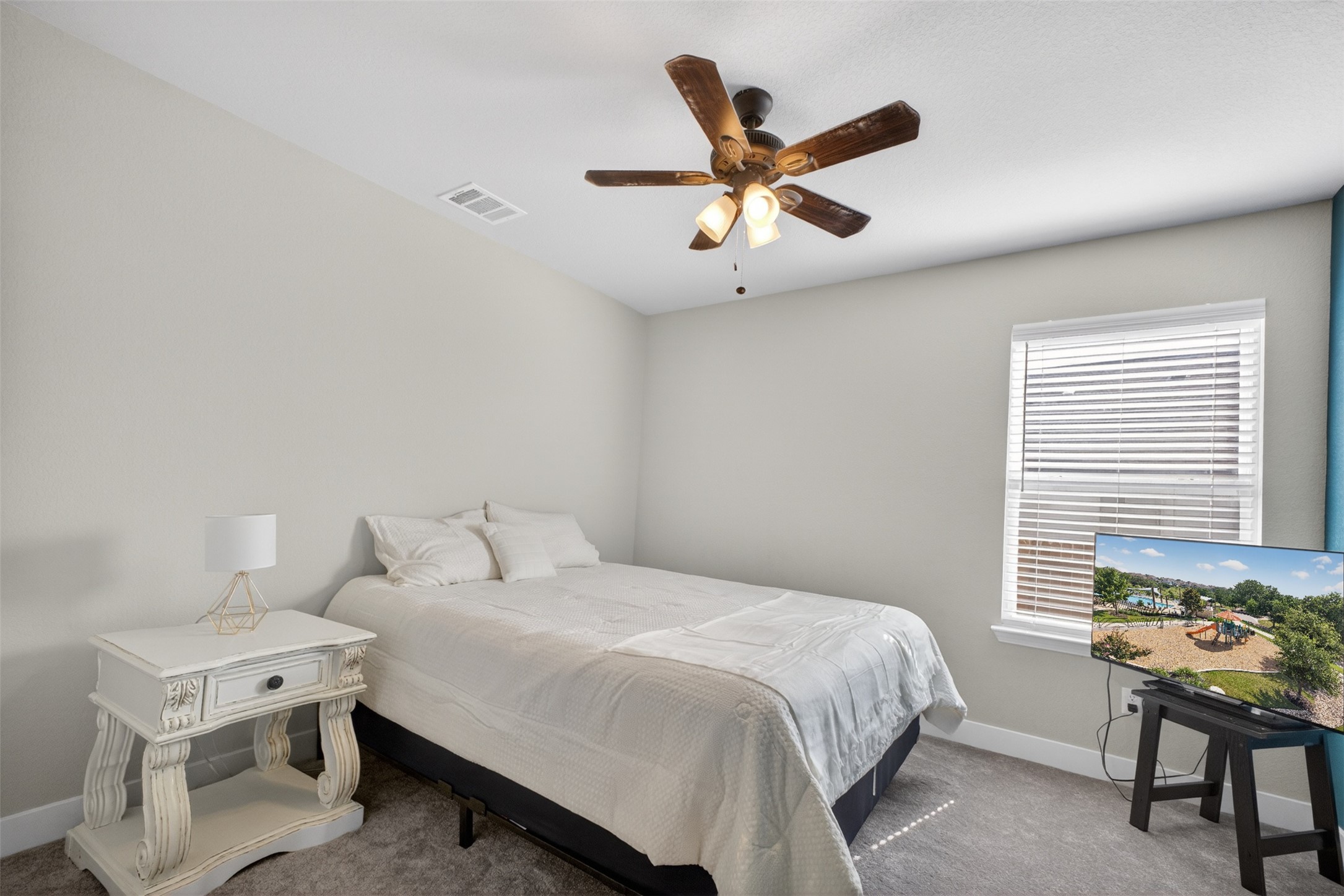 1009 Bright Star Cove Georgetown, TX 78628 - Photo 22 of 40 a bedroom with a bed and a chandelier