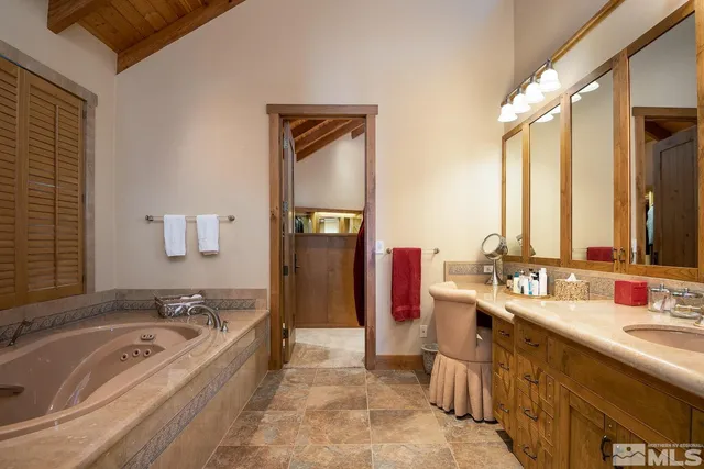 a spacious bathroom with a bathtub sink and mirror