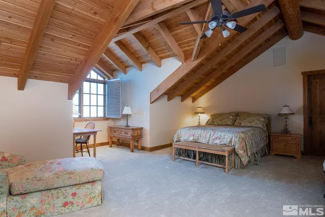 a spacious bedroom with a bed and a furniture