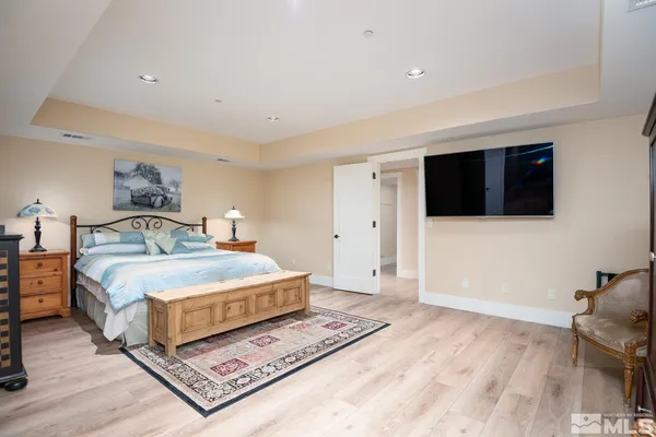 a bedroom with a bed and a television