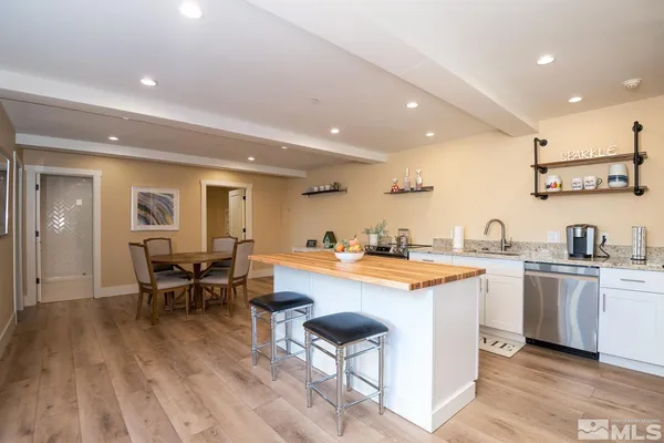 a large dining hall with stainless steel appliances granite countertop a stove and a sink