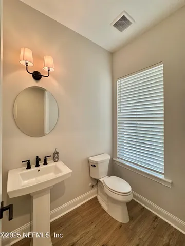a bathroom with a sink a toilet and mirror
