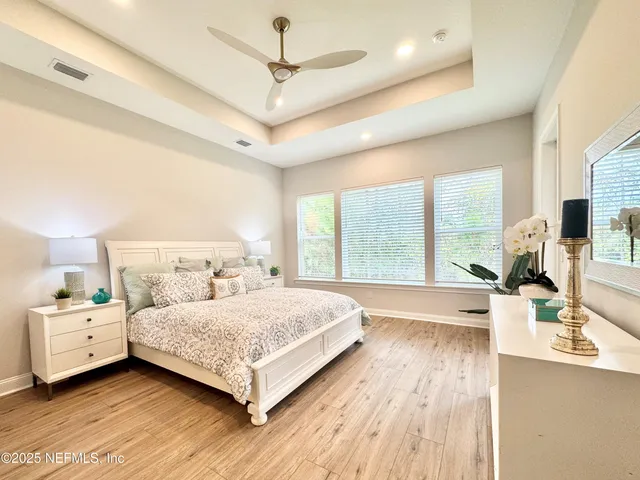 a bedroom with a large bed and a large window