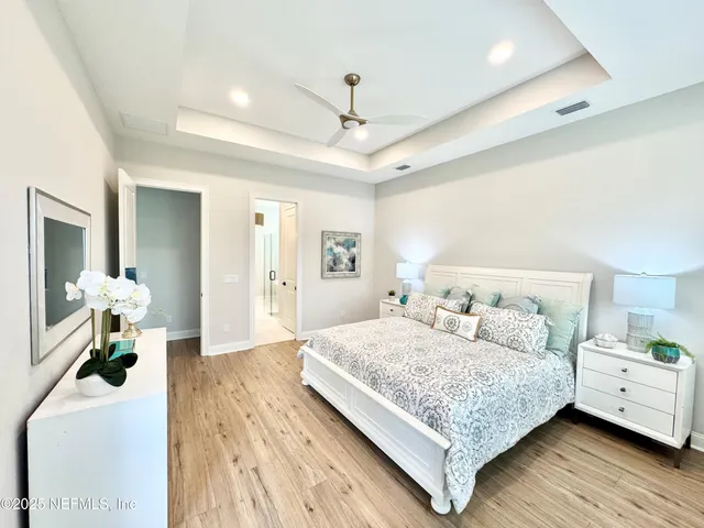 a bedroom with a bed and a chandelier