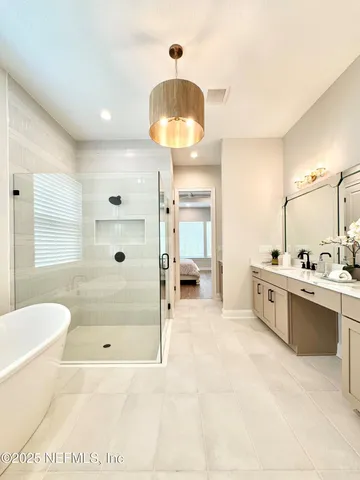 a large spacious bathroom with a tub shower and sink
