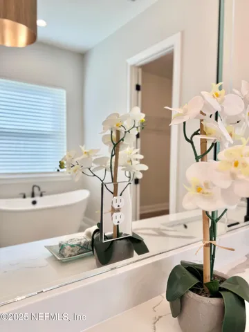 a bathroom with a sink tub and a mirror