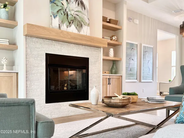 a living room with furniture a fireplace and sink