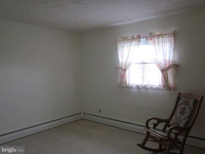 419 Reckord Road Fallston, MD 21047 - Photo 19 of 28 an empty room with windows and chair