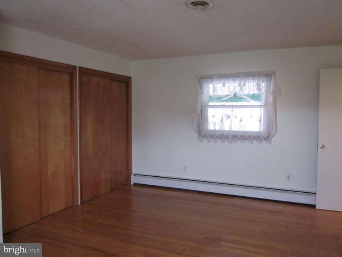 419 Reckord Road Fallston, MD 21047 - Photo 21 of 28 an empty room with wooden floor closet and windows