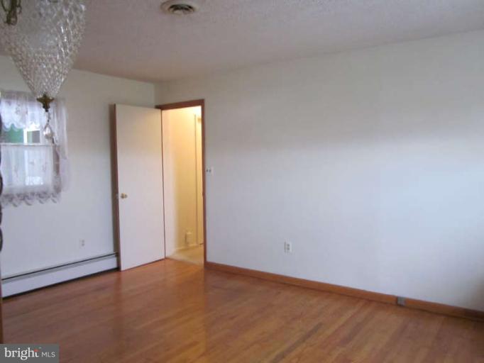419 Reckord Road Fallston, MD 21047 - Photo 22 of 28 a view of an empty room with wooden floor and a window