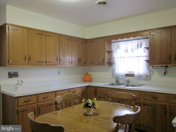 419 Reckord Road Fallston, MD 21047 - Photo 26 of 28 a kitchen with a table chairs sink and cabinets