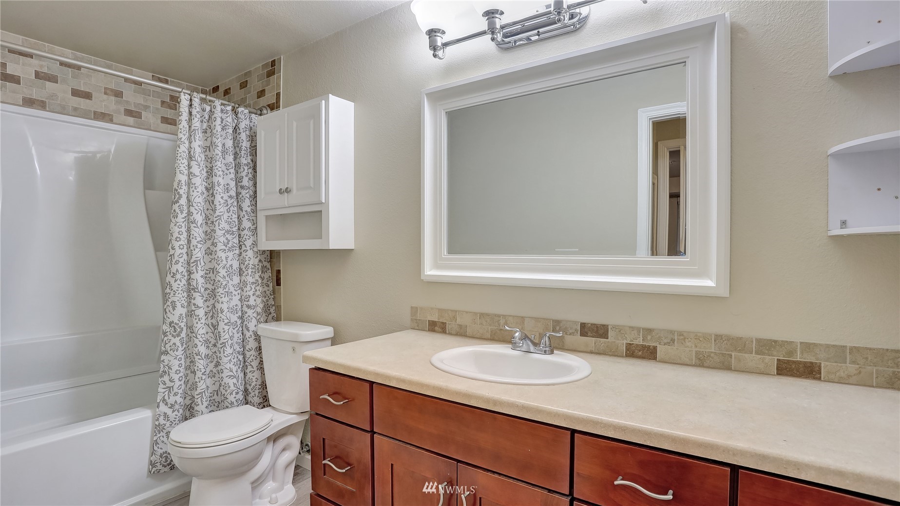 11002 Southeast Petrovitsky Road, Unit H101 Renton, WA 98055 - Photo 21 of 30 a bathroom with a sink toilet double vanity and shower