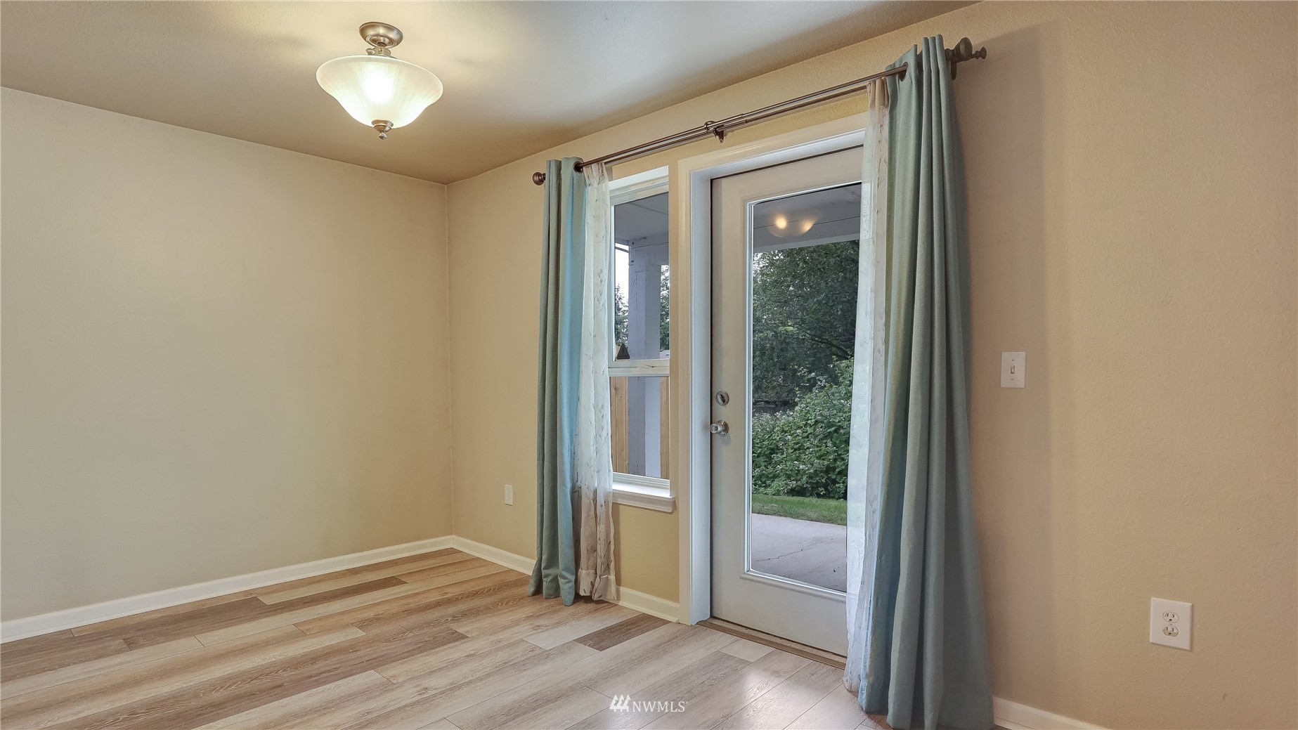 11002 Southeast Petrovitsky Road, Unit H101 Renton, WA 98055 - Photo 9 of 30 a view of an empty room and glass door
